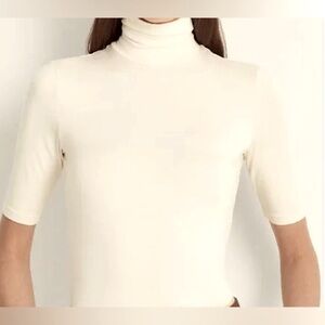 Cream express lightweight turtleneck sweater with sleeves to elbow.